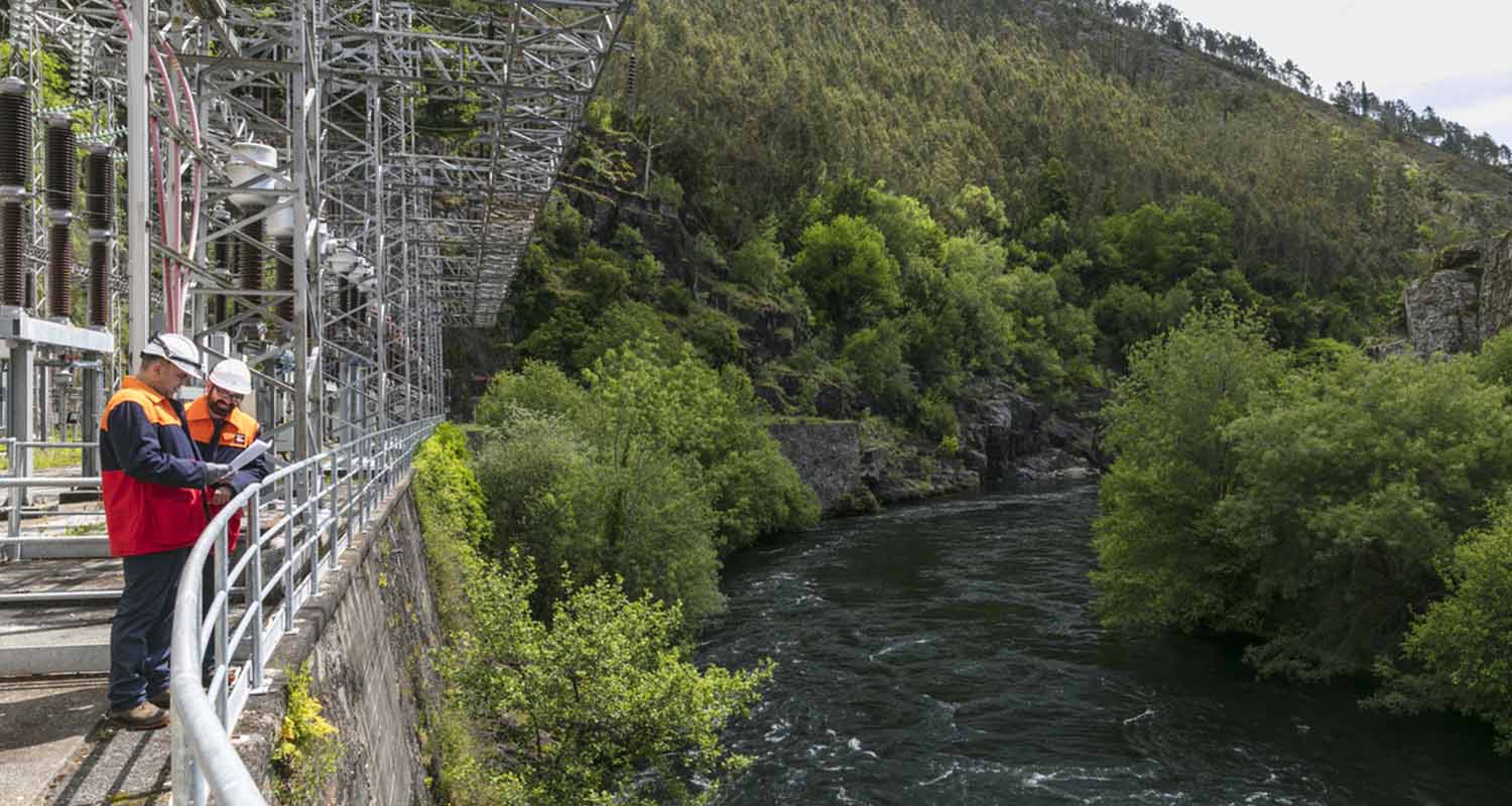 Repsol operators overlooking a dam