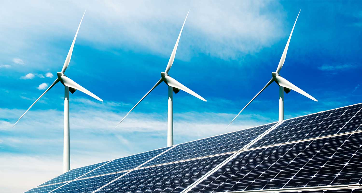 Wind turbines behind solar panels