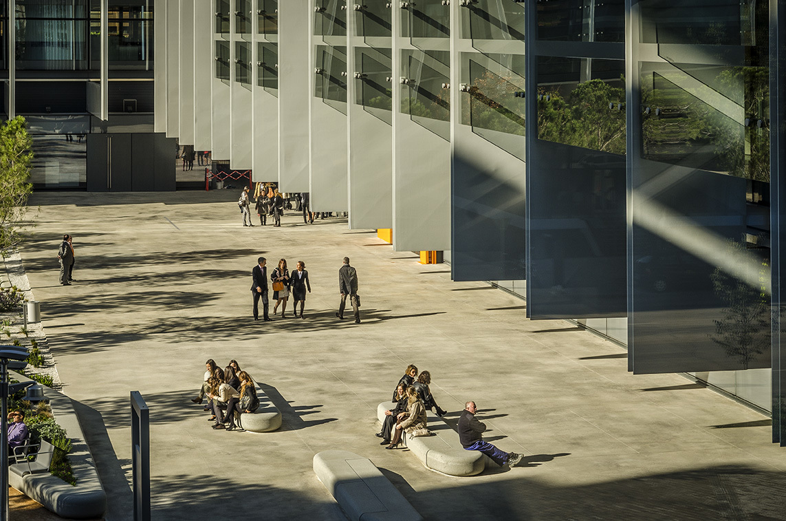 People walking around the Repsol Campus courtyard