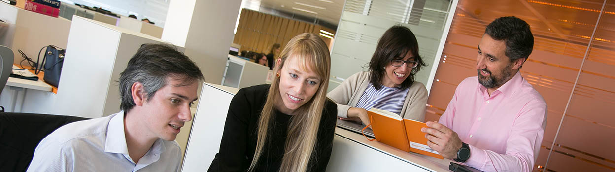 A group of people chatting in an office