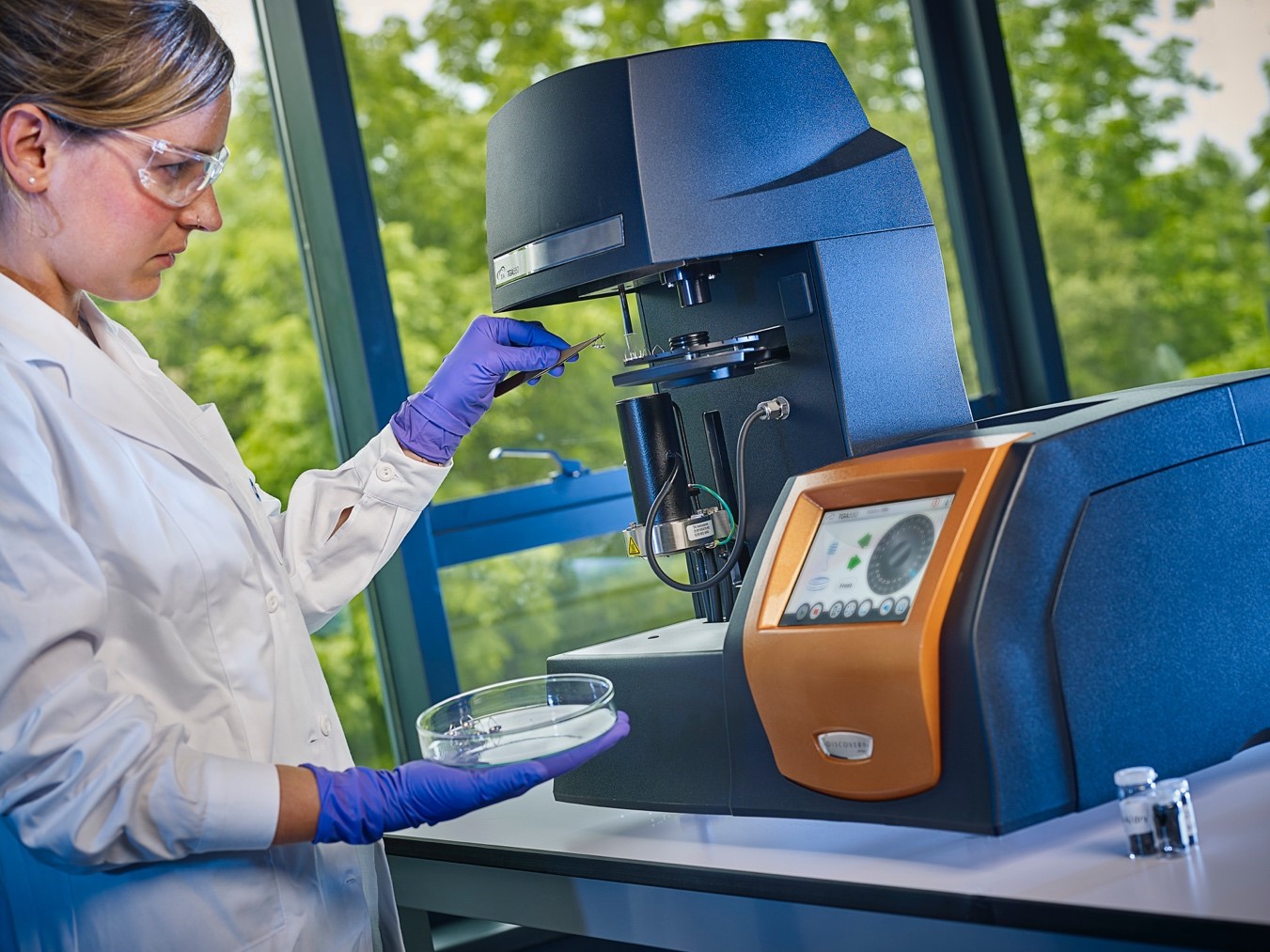 A female researcher consulting samples in a laboratory