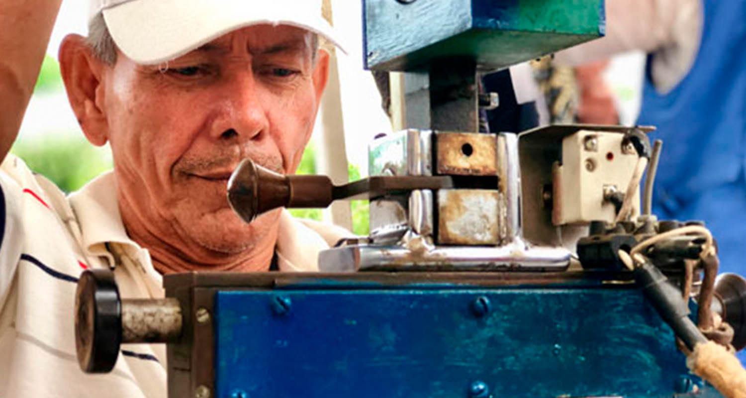 A person performs a job with an artisanal machine.